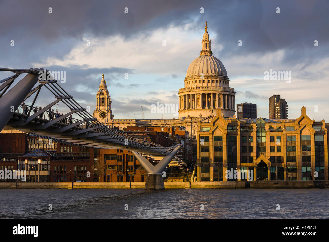 St. Paul's Cathedral and the Millenium Bridge with late afternoon light illuminating