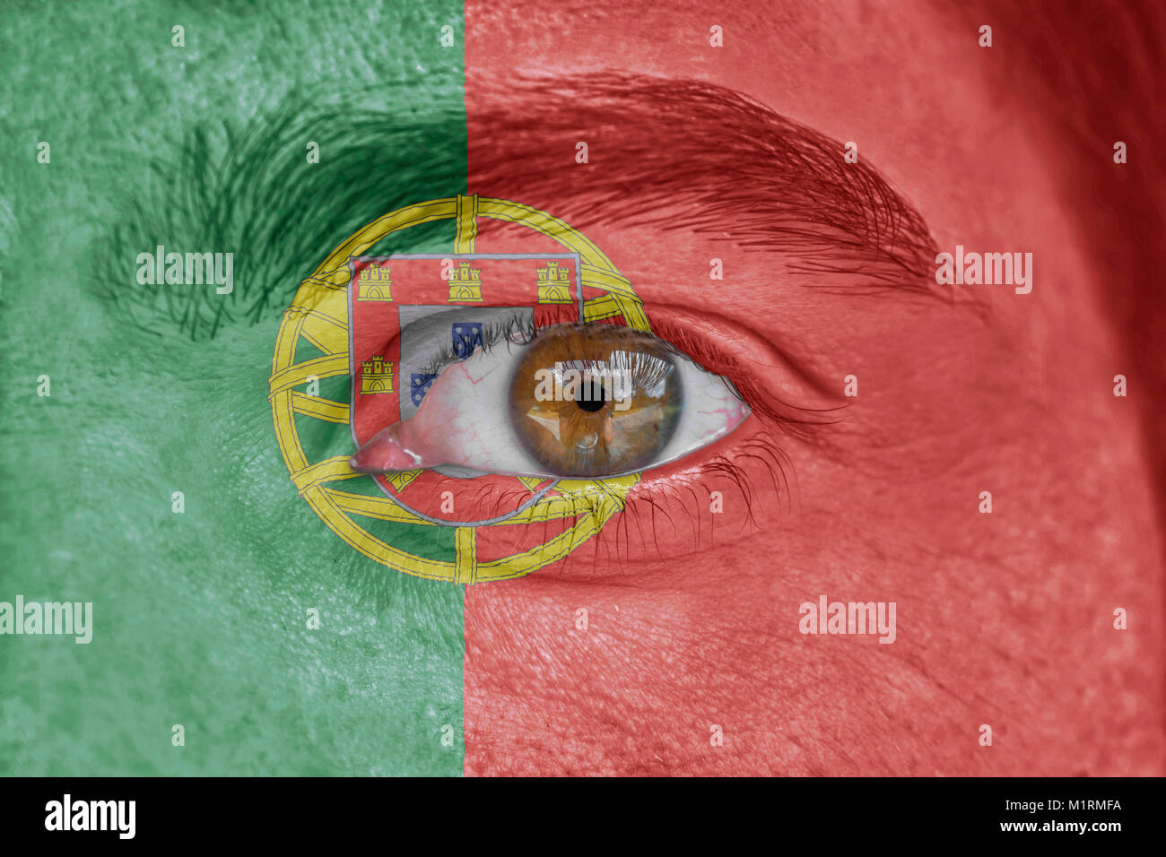 Human face and eye painted with flag of Portugal Stock Photo