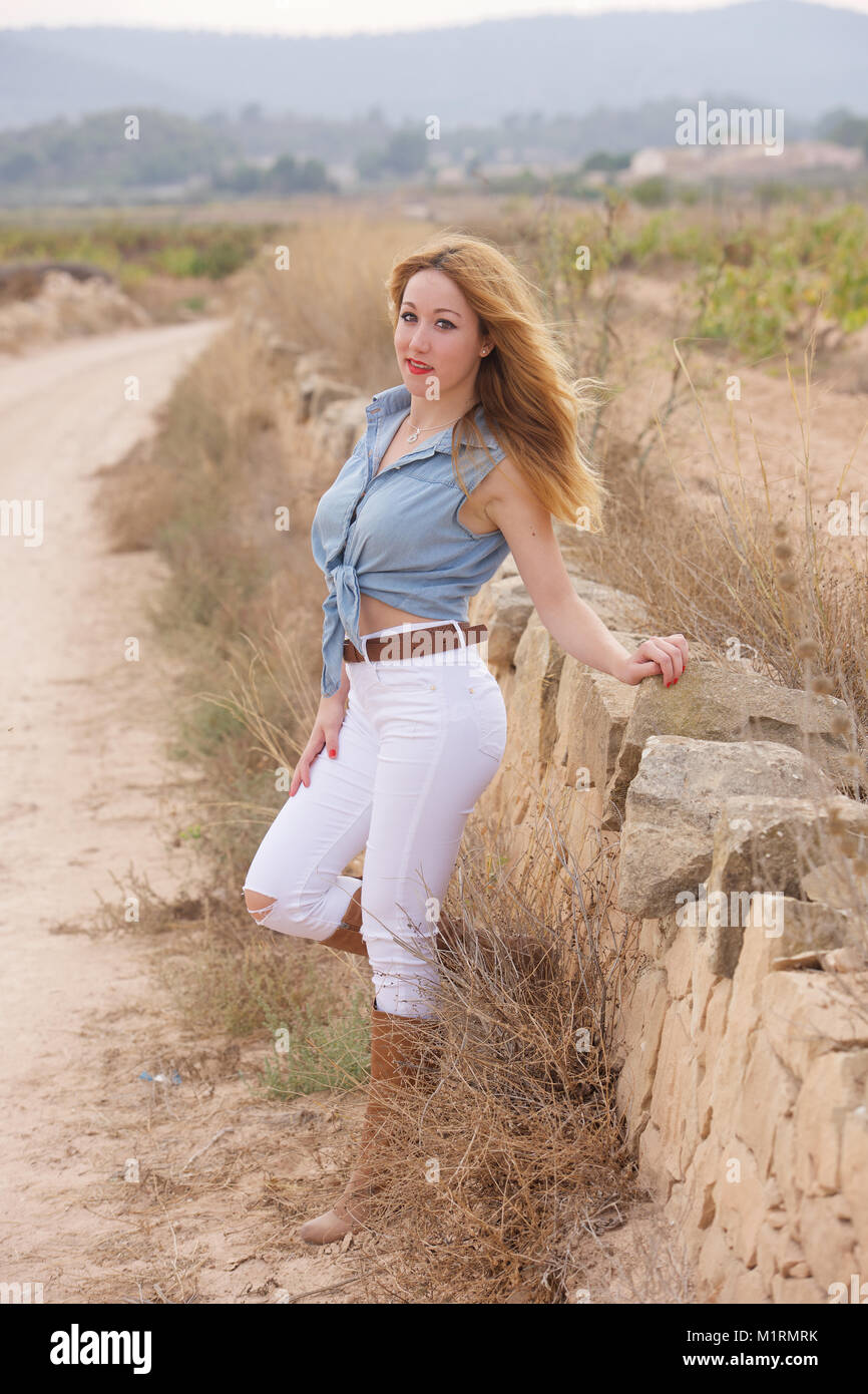 Beautiful girl wearing tight jeans and boots near a vineyard Stock Photo -  Alamy