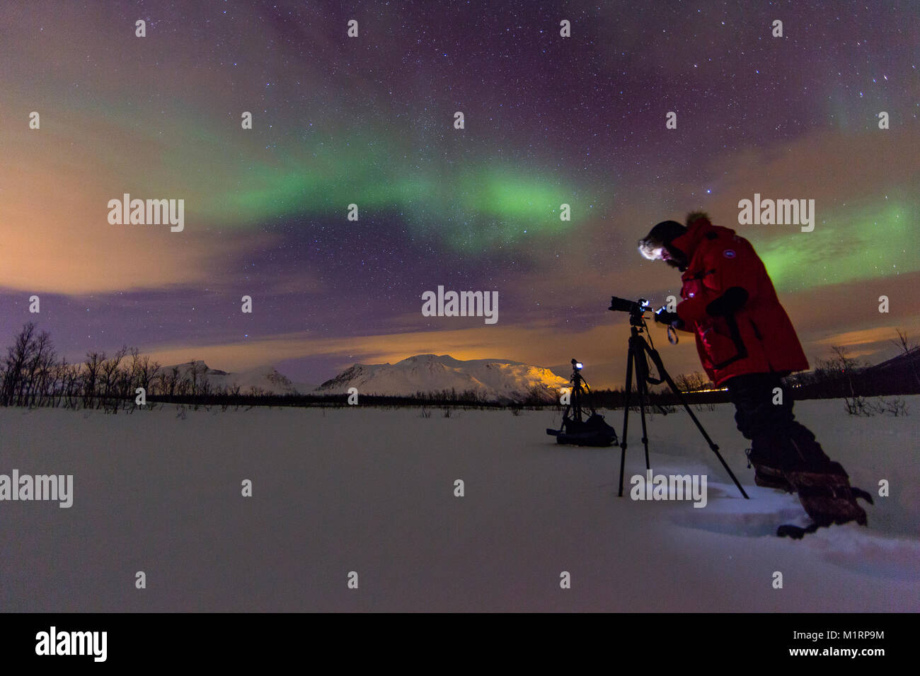 Tromso, Norway. Alister Chapman filming northern lights display. Stock Photo