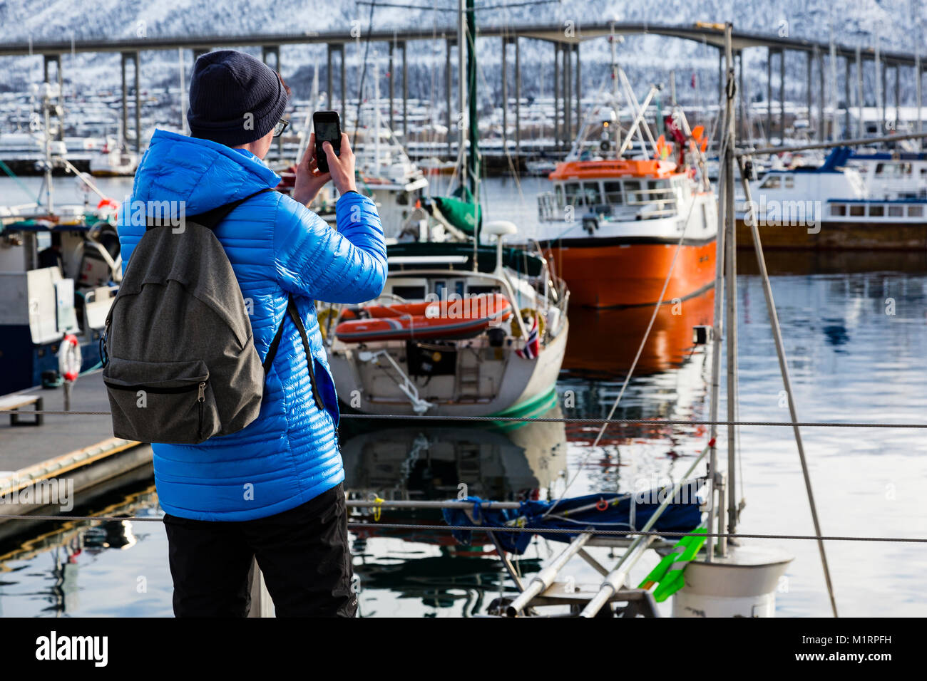Tromso Port, Norway. Chai Cameron taking photographs at Tromso port. Stock Photo