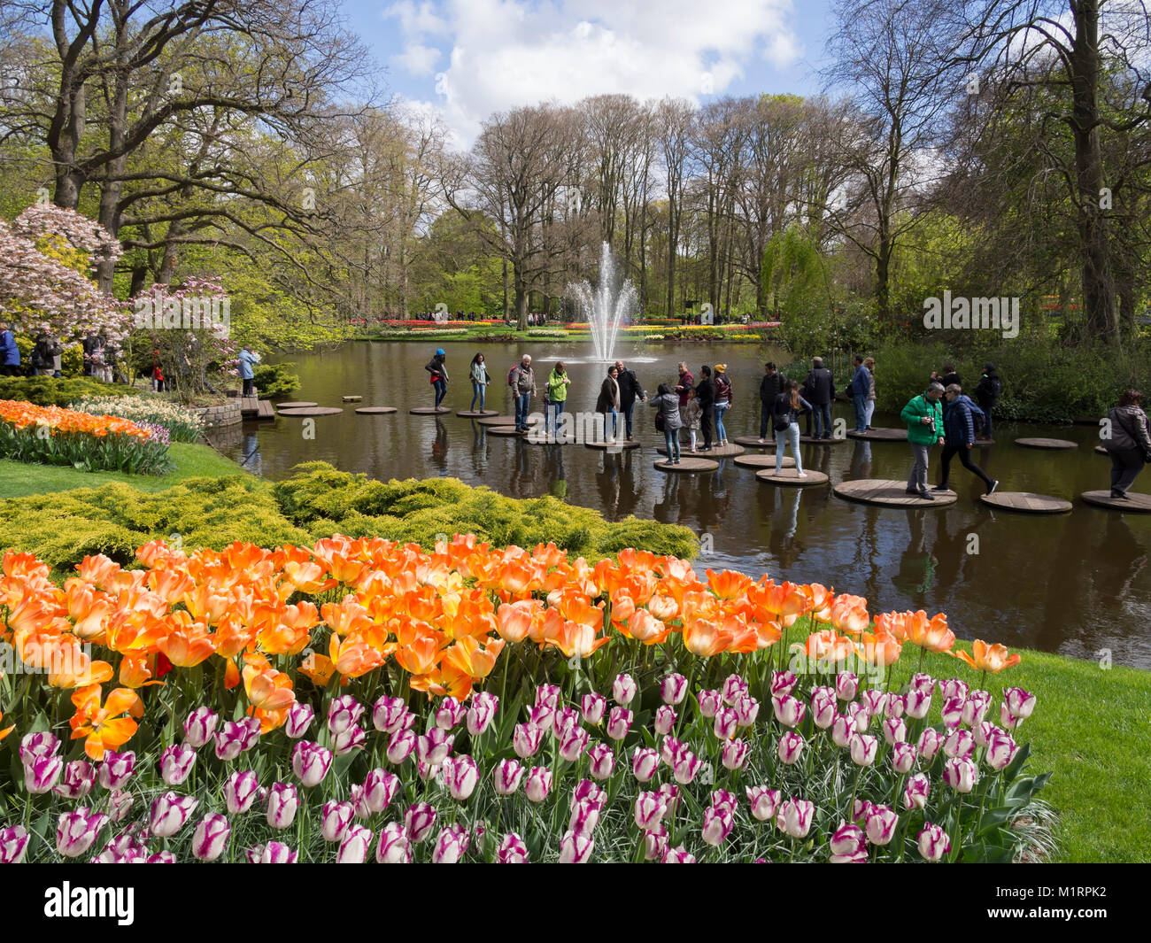 Visitors try stepping stones at Keukenhof Gardens Stock Photo