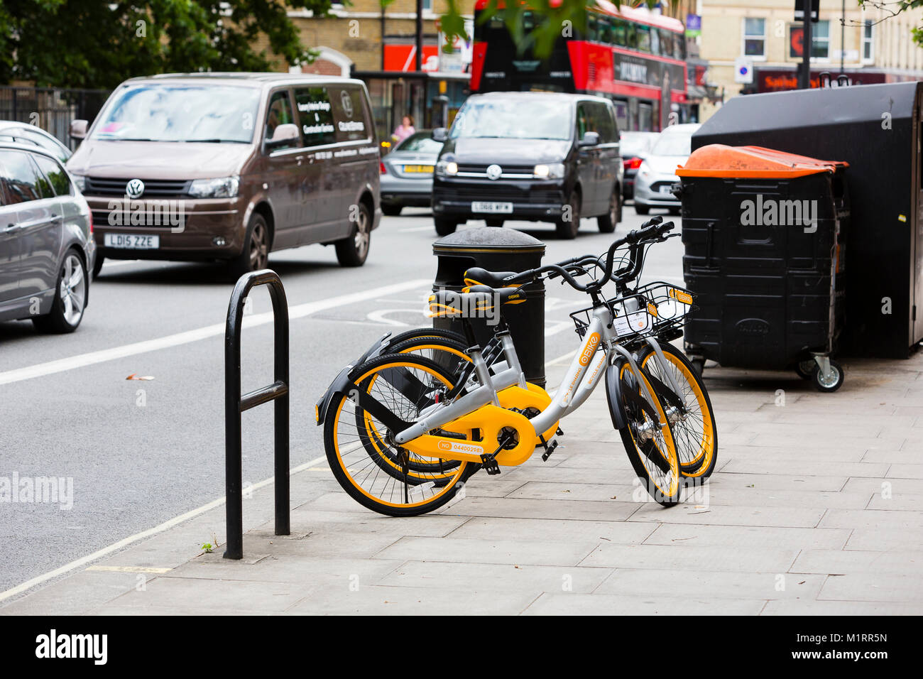 LONDON, ENGLAND. A pair of OBikes waiting for riders in Fulham following the company's troubled launch in London. Stock Photo