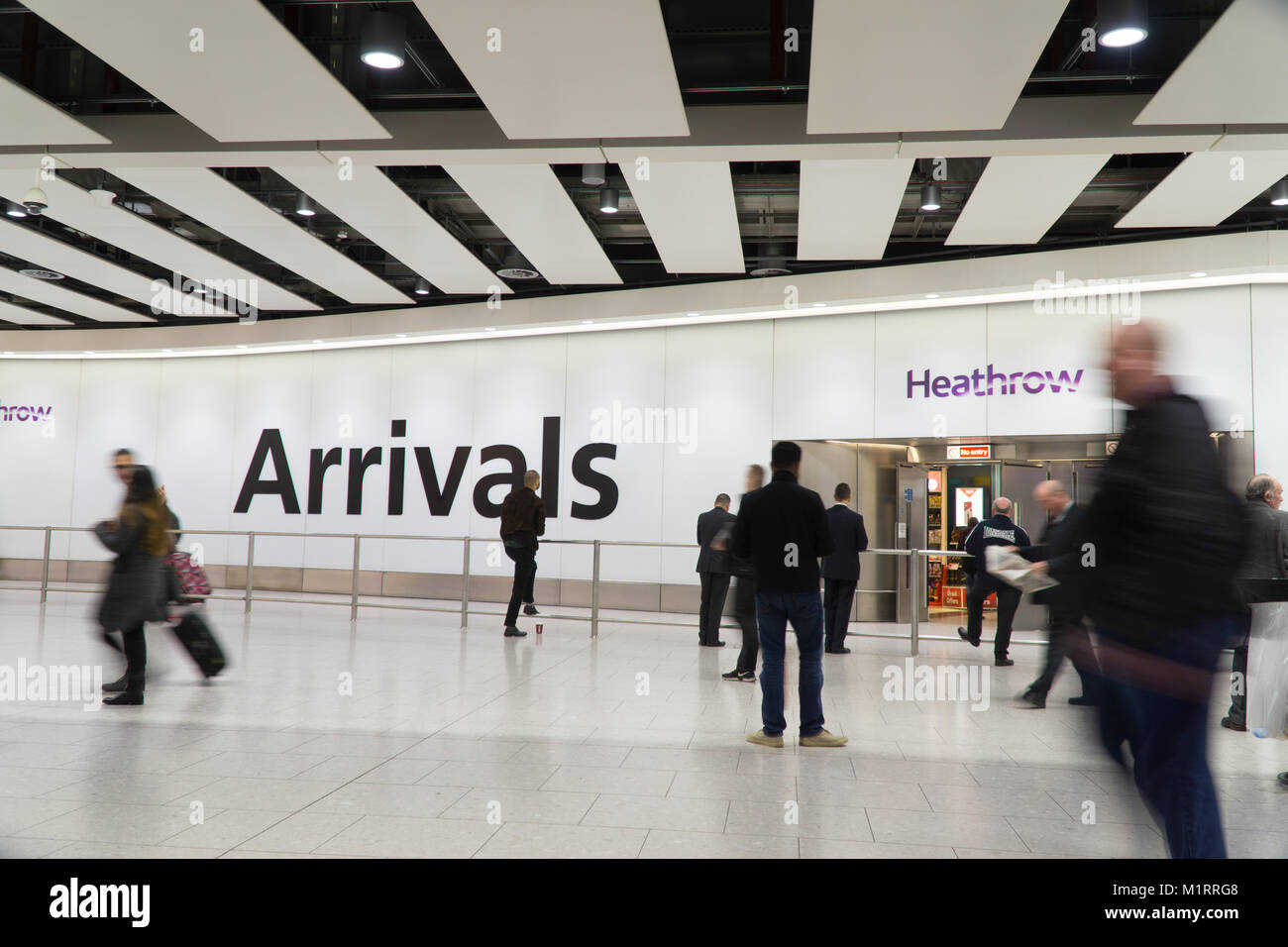 Slow camera shutter speed emphasising movement at arrivals area Heathrow Terminal 4,England Stock Photo