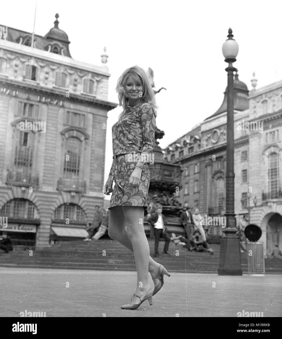 A model poses in a mini dress outdoors in London's Piccadilly near the statue of Eros in circa 1968 wearing a colourful mini-dress.   Photo by Tony Henshaw Stock Photo