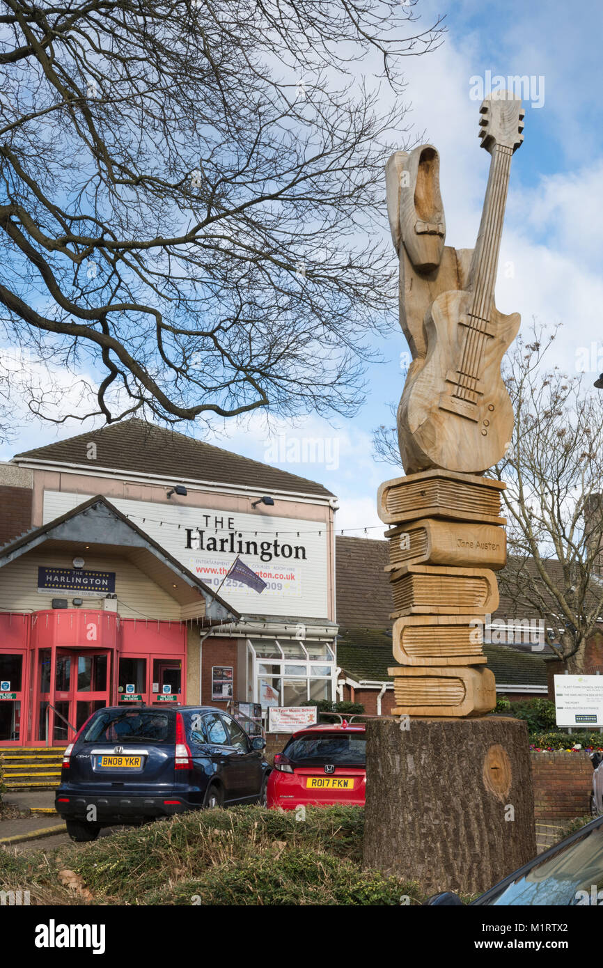 A carved wooden sculpture outside the Harlington Centre - an events venue and library in Fleet town centre, Hampshire, UK Stock Photo