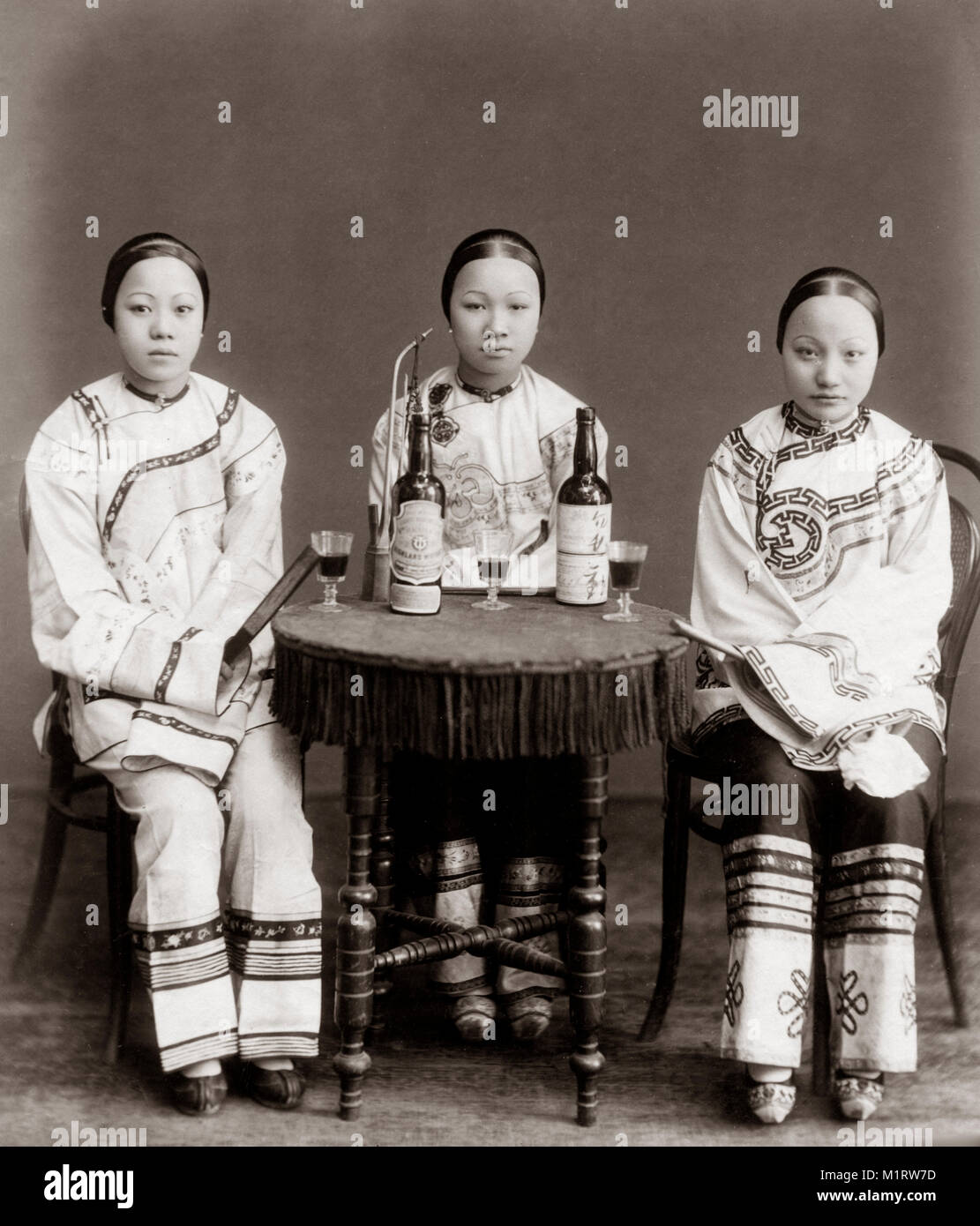 c.1880 Chinese prostitutes with a Scotch whisky bottle and glasses Stock Photo Alamy