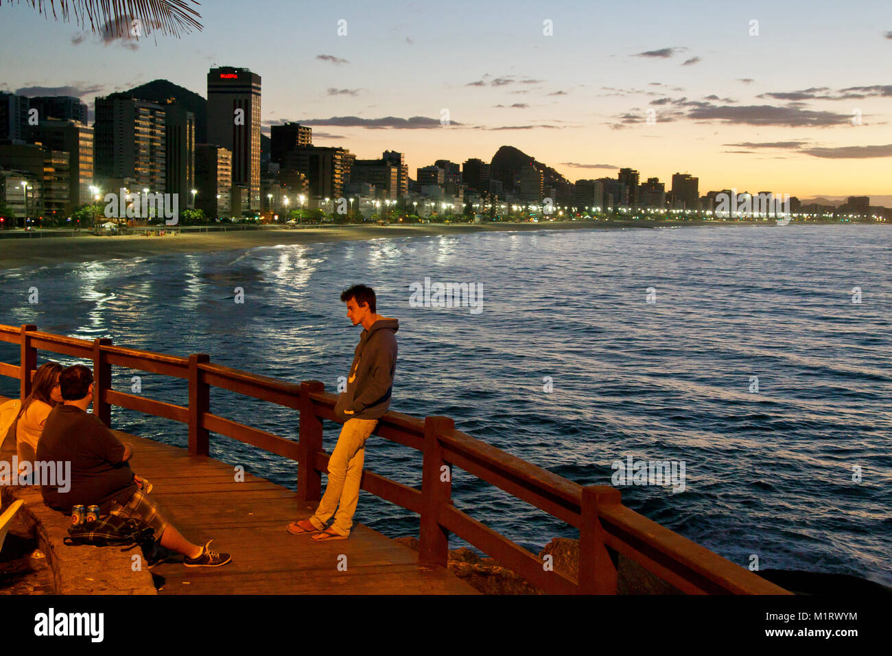 People enjoying the early morning at Av. Niemayer viewpoint with Leblon Beach on the background , Rio de Janeiro, Brazil Stock Photo