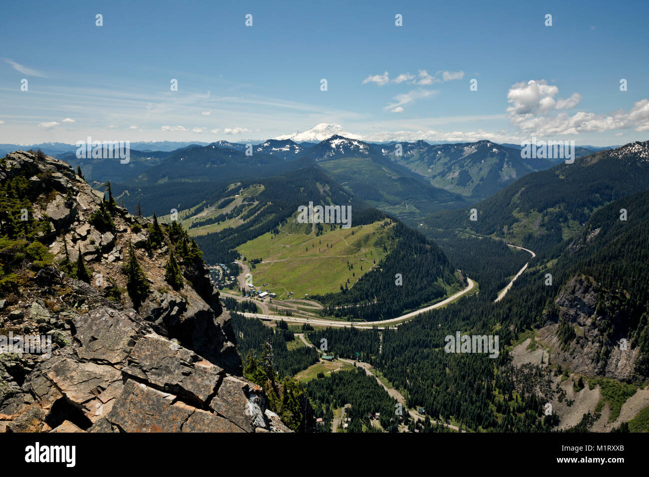 WASHINGTON- Snoqualmie Pass ski areas and Interstate 90 with Mount Rainier to the south from Guye Peak in the Mount Baker - Snoqualmie National Forest Stock Photo