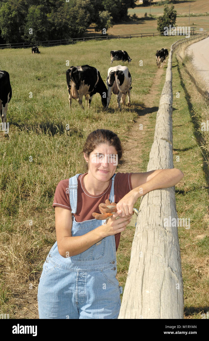 portrait of a farmer with her cows in the field Stock Photo - Alamy