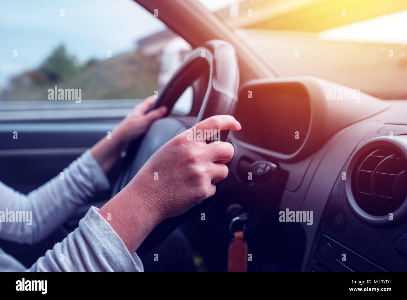 Woman with hands on car steering wheel hires stock photography and