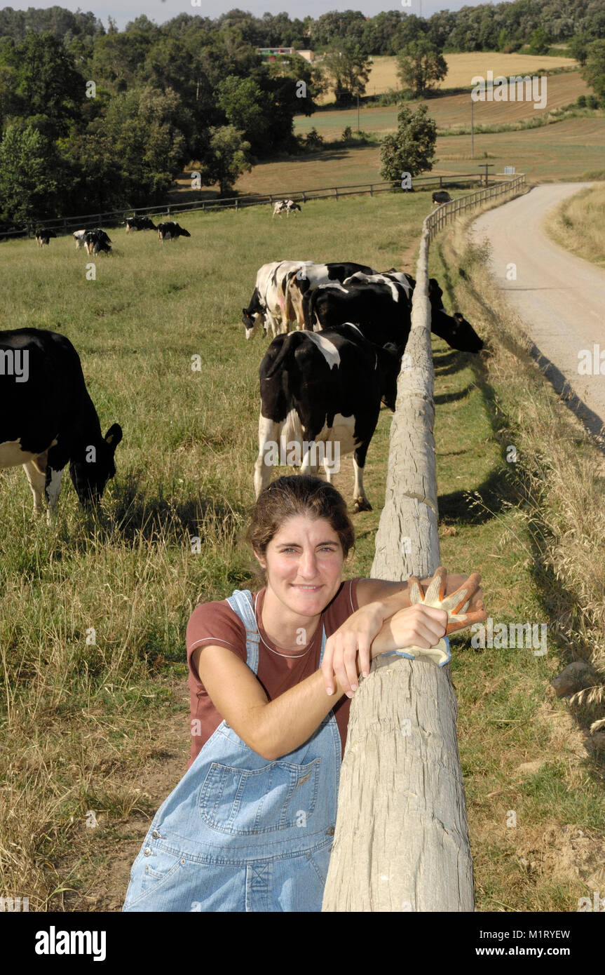portrait of a farmer with her cows in the field Stock Photo - Alamy