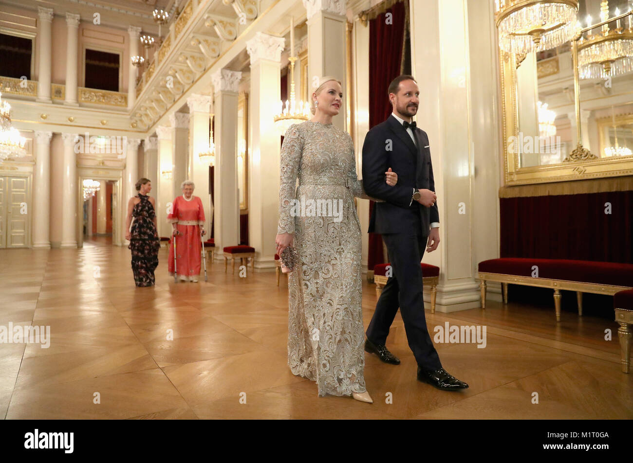 Crown Princess Mette Marit of Norway and Crown Prince Haakon of Norway walk into dinner at the Royal Palace on day three of the royal visit by the Duke and Duchess of Cambridge to Scandinavia. Stock Photo