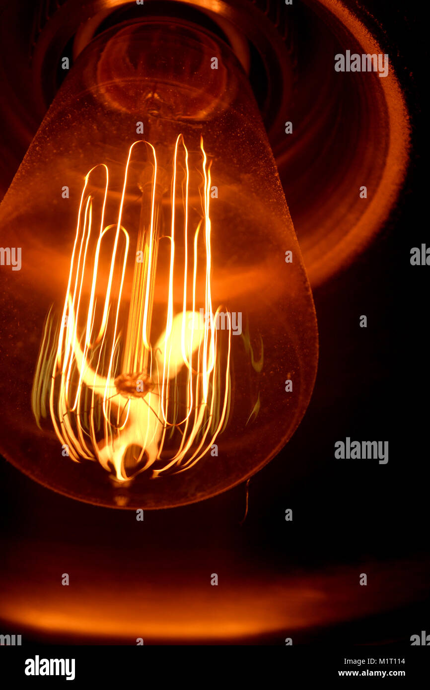 Illuminated Light Bulb In Darkroom Stock Photo Alamy