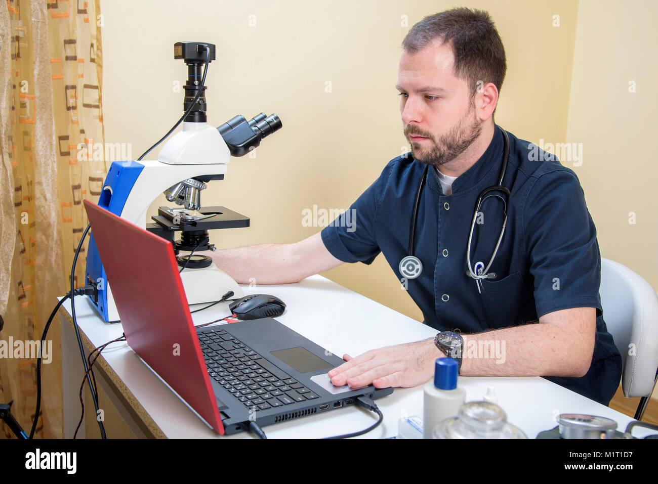 Young doctor researching on a microscope Stock Photo Alamy