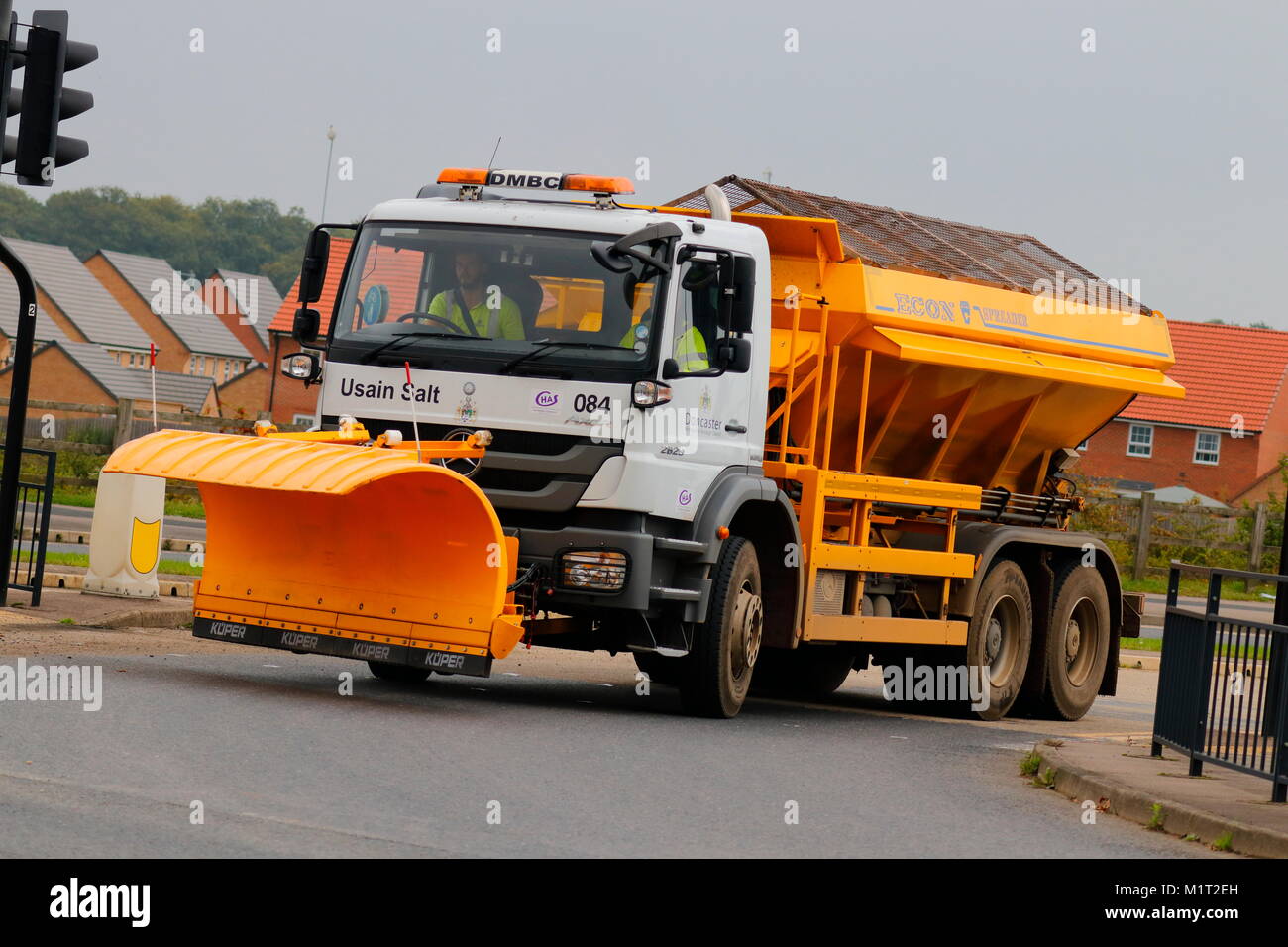 A gritter pulling out of a junction to Doncaster Sheffield Airport Stock Photo