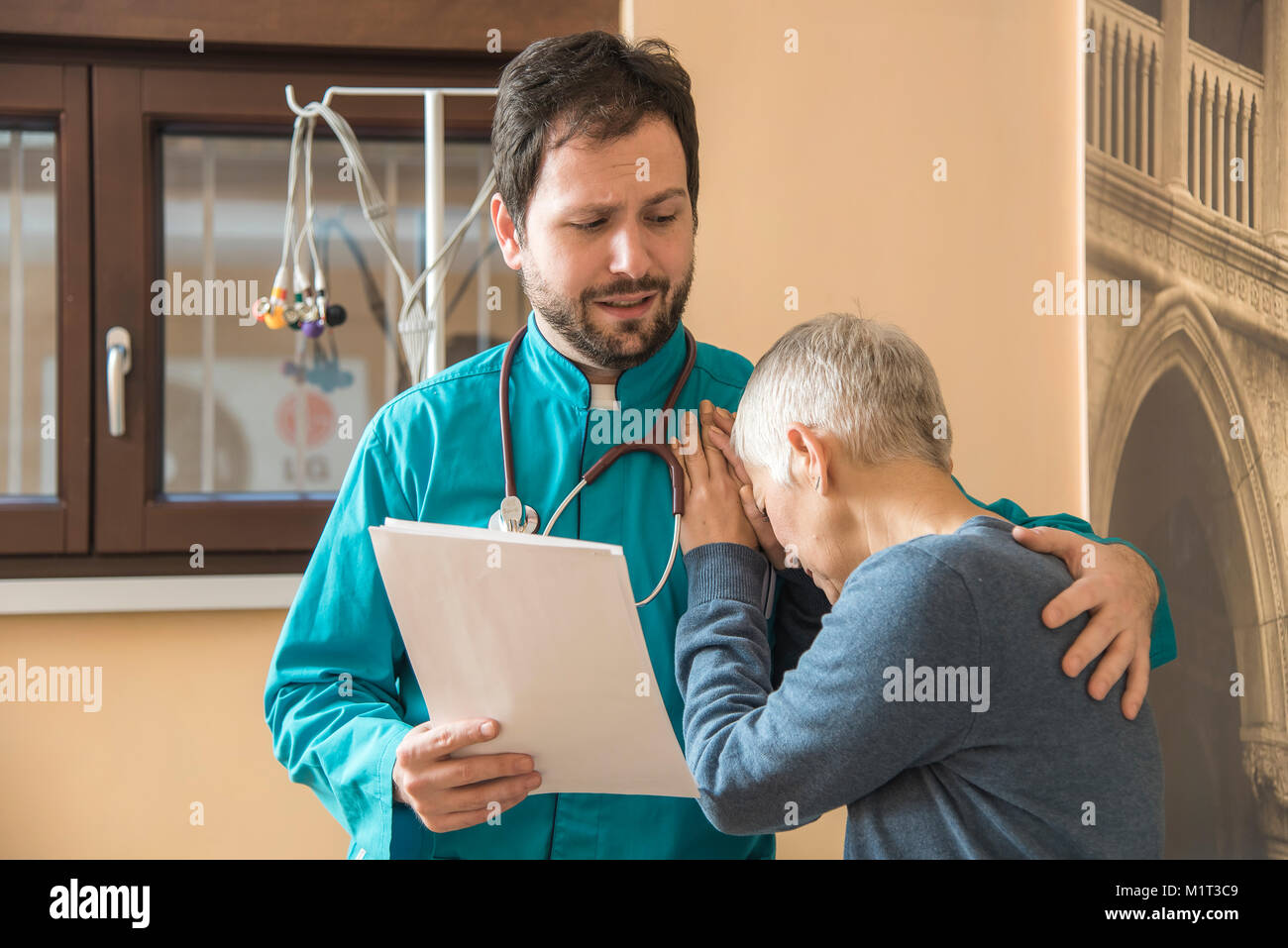 Doctor comforting his patient and showing support Stock Photo