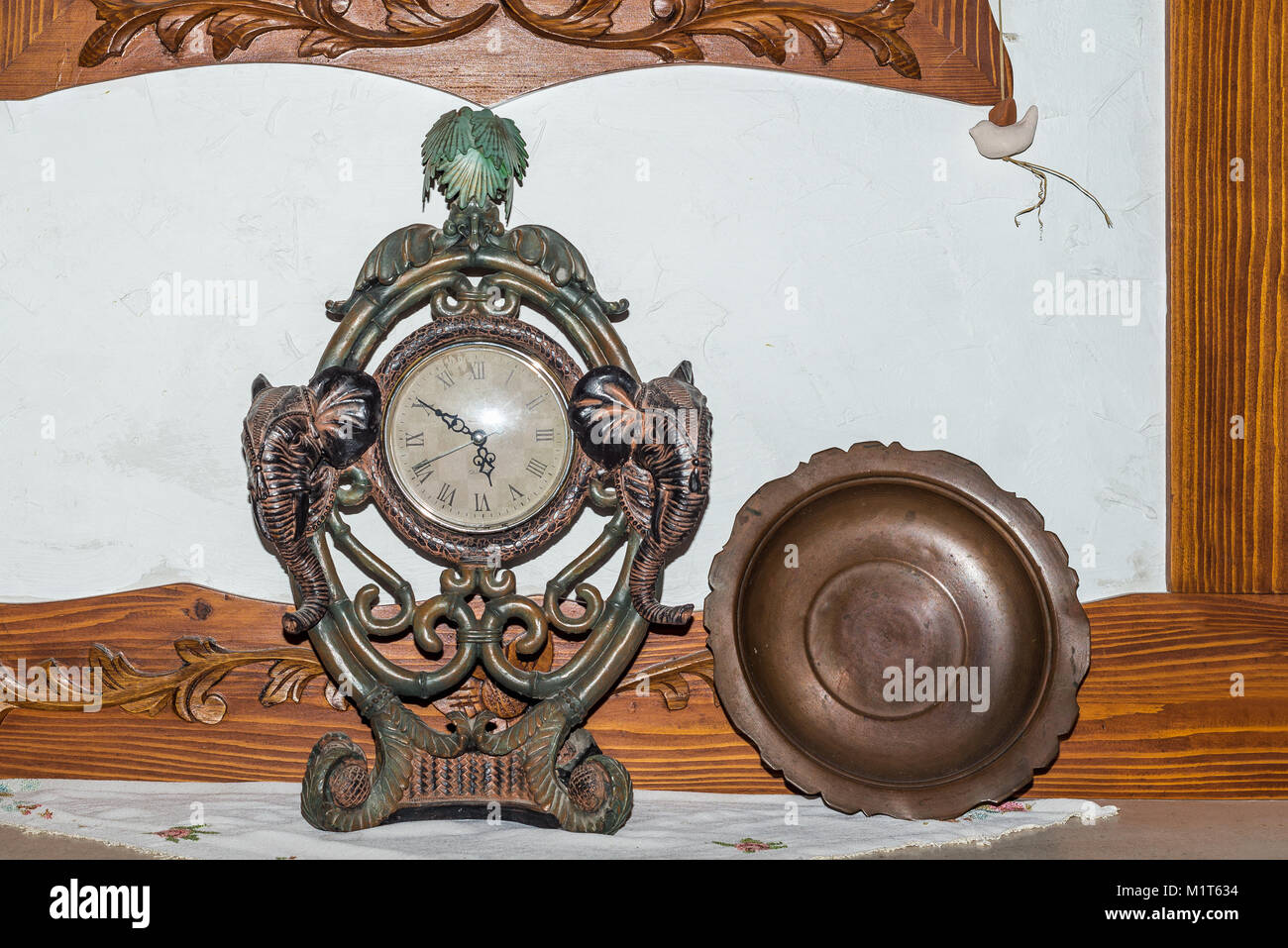 Old antique fireplace clock and bronze plate closeup Stock Photo