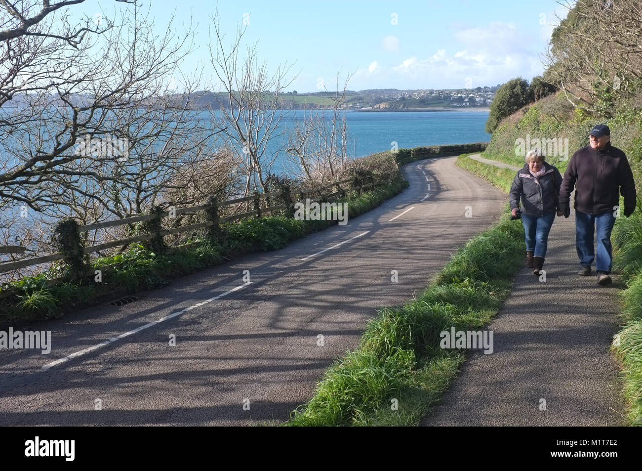 Two people walk around Pendennis Point in Falmouth Stock Photo