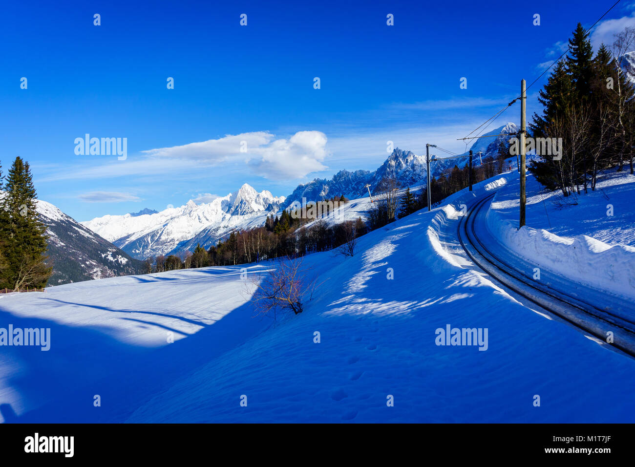 Beautiful landscape of snowy mountain view with a spruce of pine trees in Bellvue Saint-Gervais-les-Bains. Alps mountaintop near Mont Blanc. Stock Photo