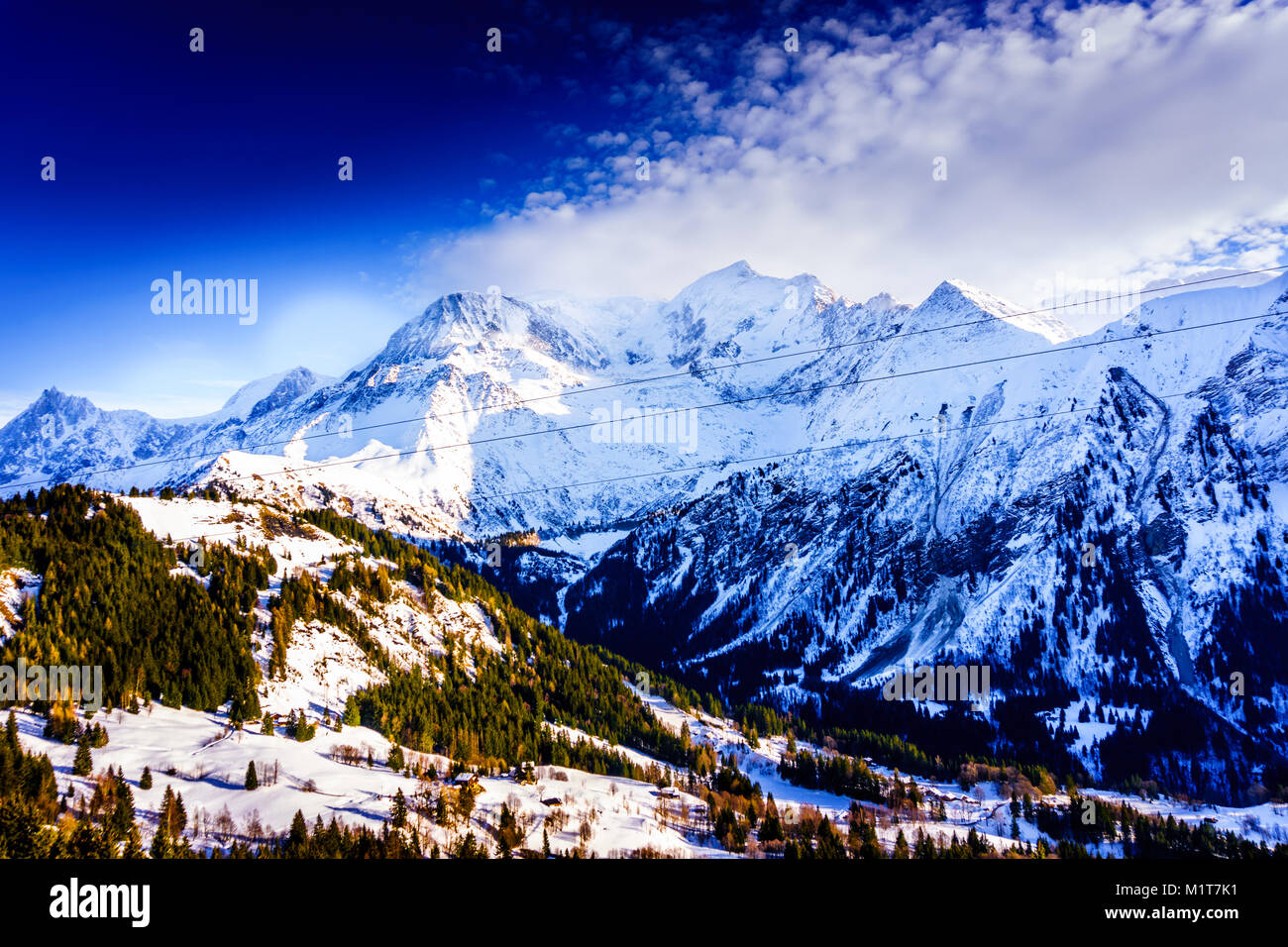 Beautiful landscape of snowy mountain view with a spruce of pine trees in Bellvue Saint-Gervais-les-Bains. Alps mountaintop near Mont Blanc. Stock Photo