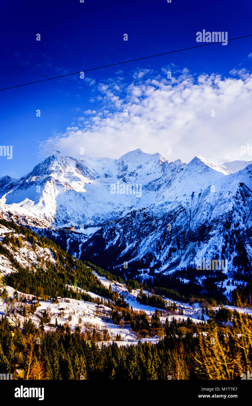 Beautiful landscape of snowy mountain view with a spruce of pine trees in Bellvue Saint-Gervais-les-Bains. Alps mountaintop near Mont Blanc. Stock Photo