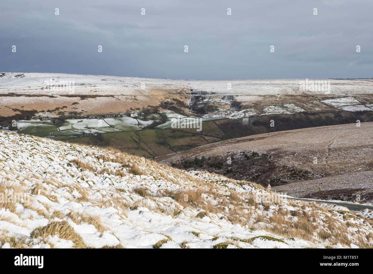 Small remote community on snowy moorlands above Marsden in West Yorkshire Stock Photo