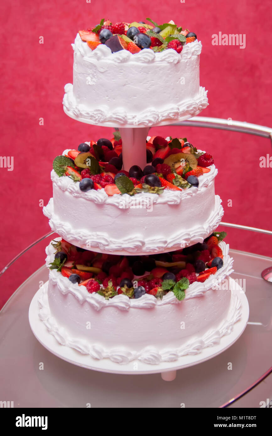 Wedding cake decorated with flowers and berries Stock Photo - Alamy