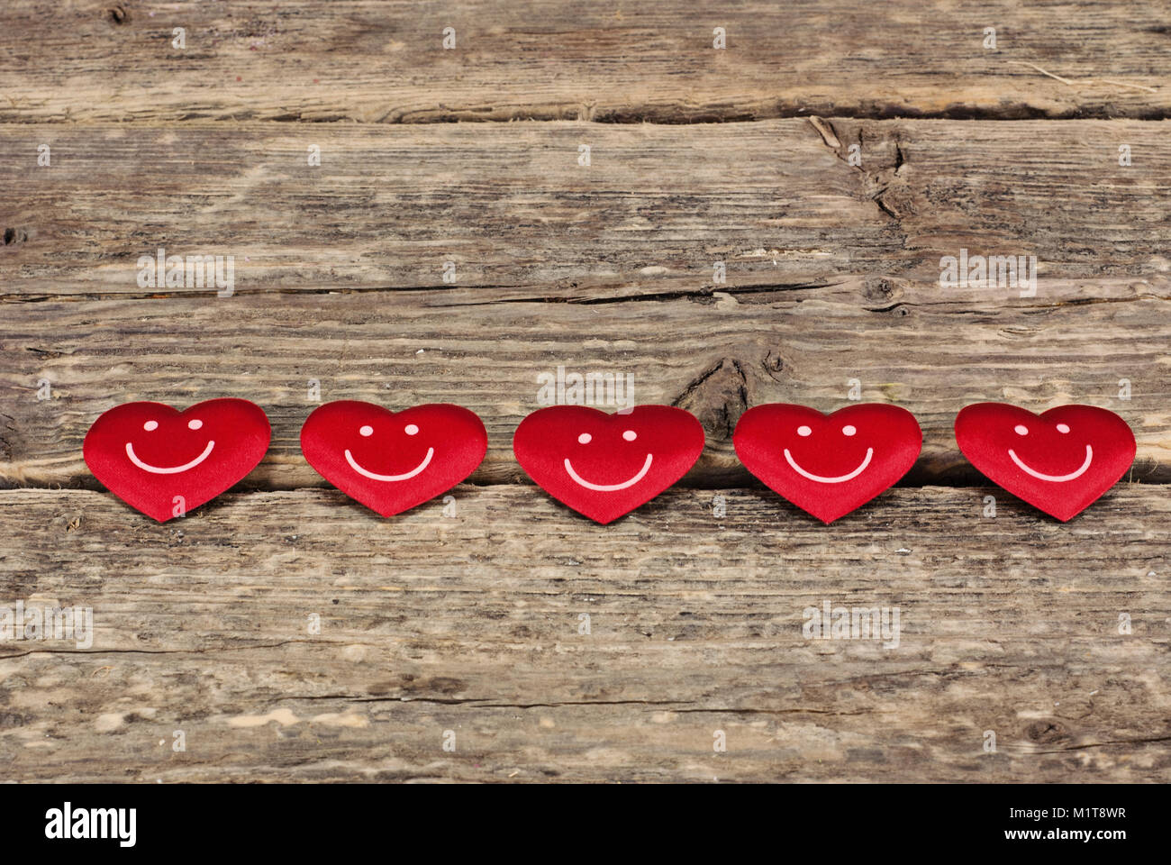 Valentine's day red hearts on old wooden background. Greeting card with ...