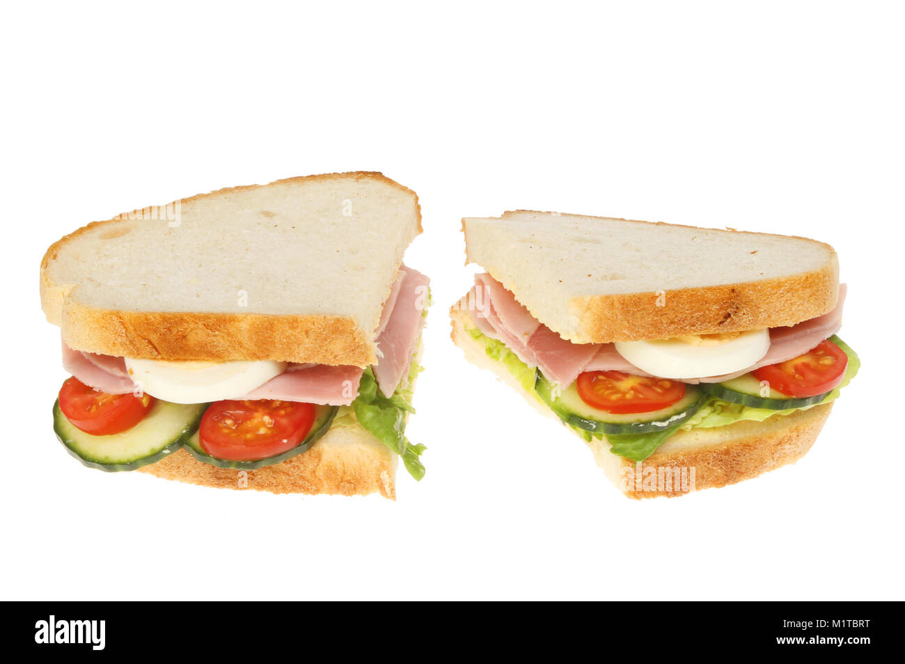 Ham, egg and sald sandwiches isolated against white Stock Photo