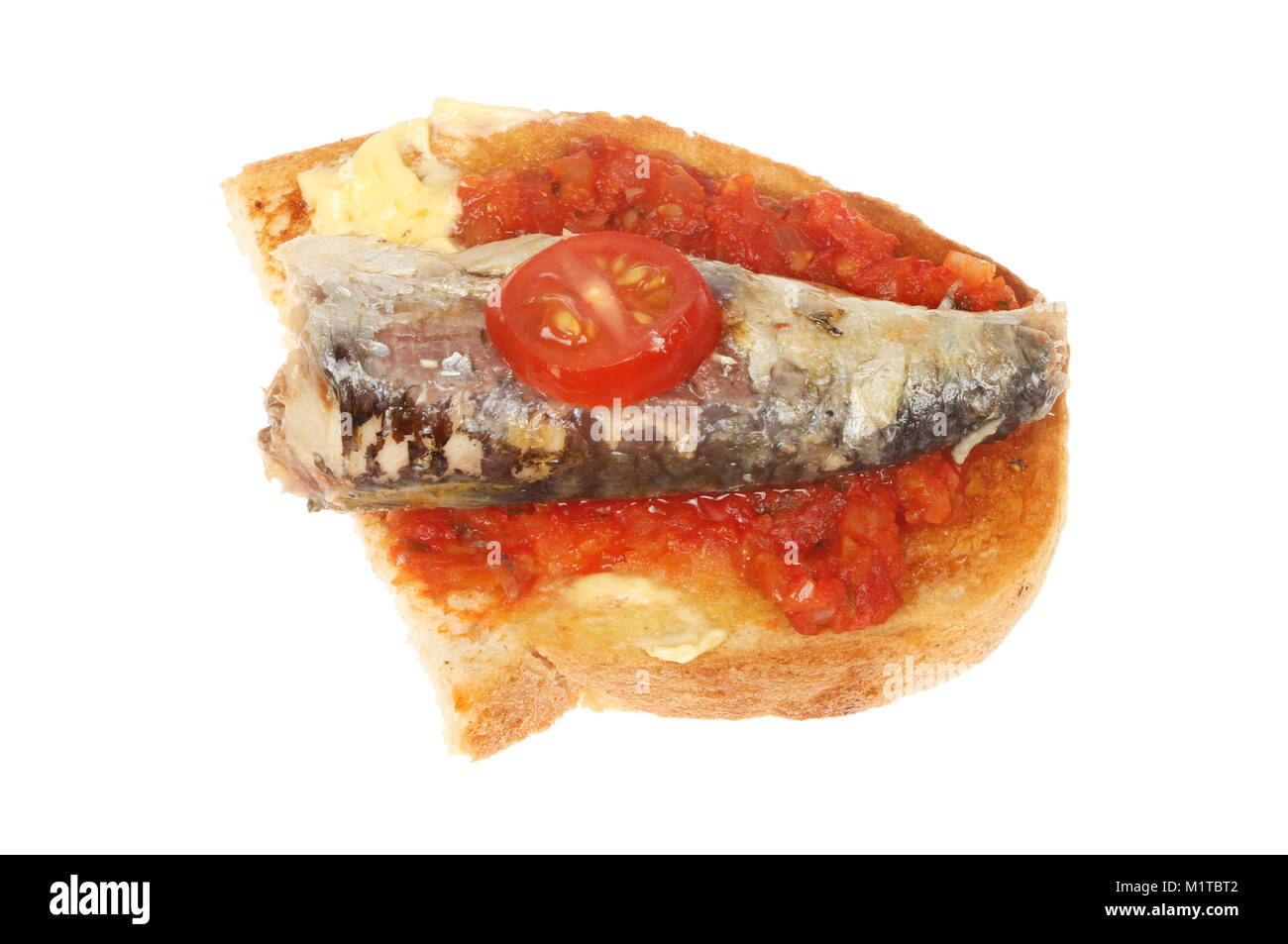 Sardine and tomato on buttered toast isolated against white Stock Photo