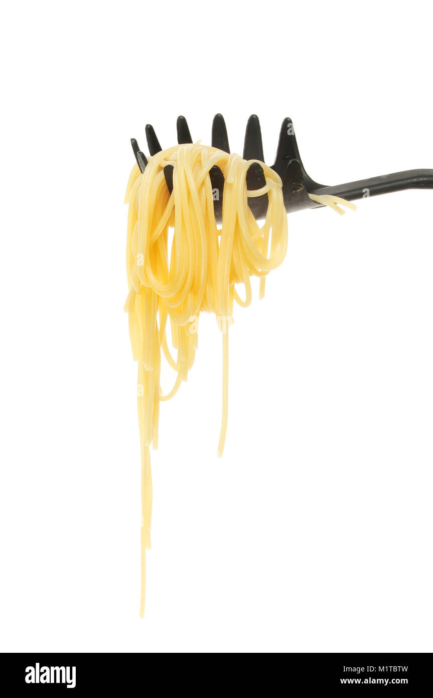 Spaghetti in a draining spoon isolated against white Stock Photo Alamy