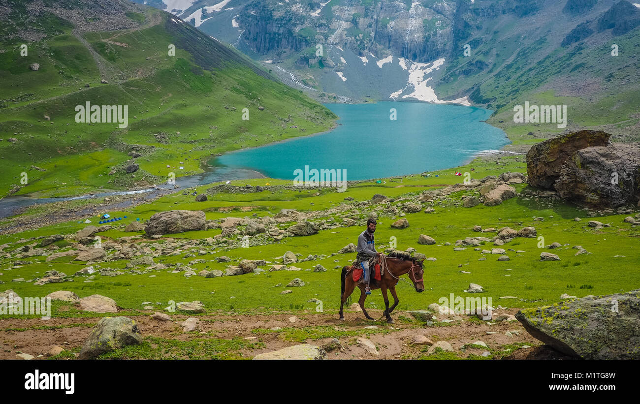 Kashmir, India -July 06: Unidentified man with horse on Sonamarg mountain on July 06, 2017. There are people of Kashmir who live on the mountain Stock Photo
