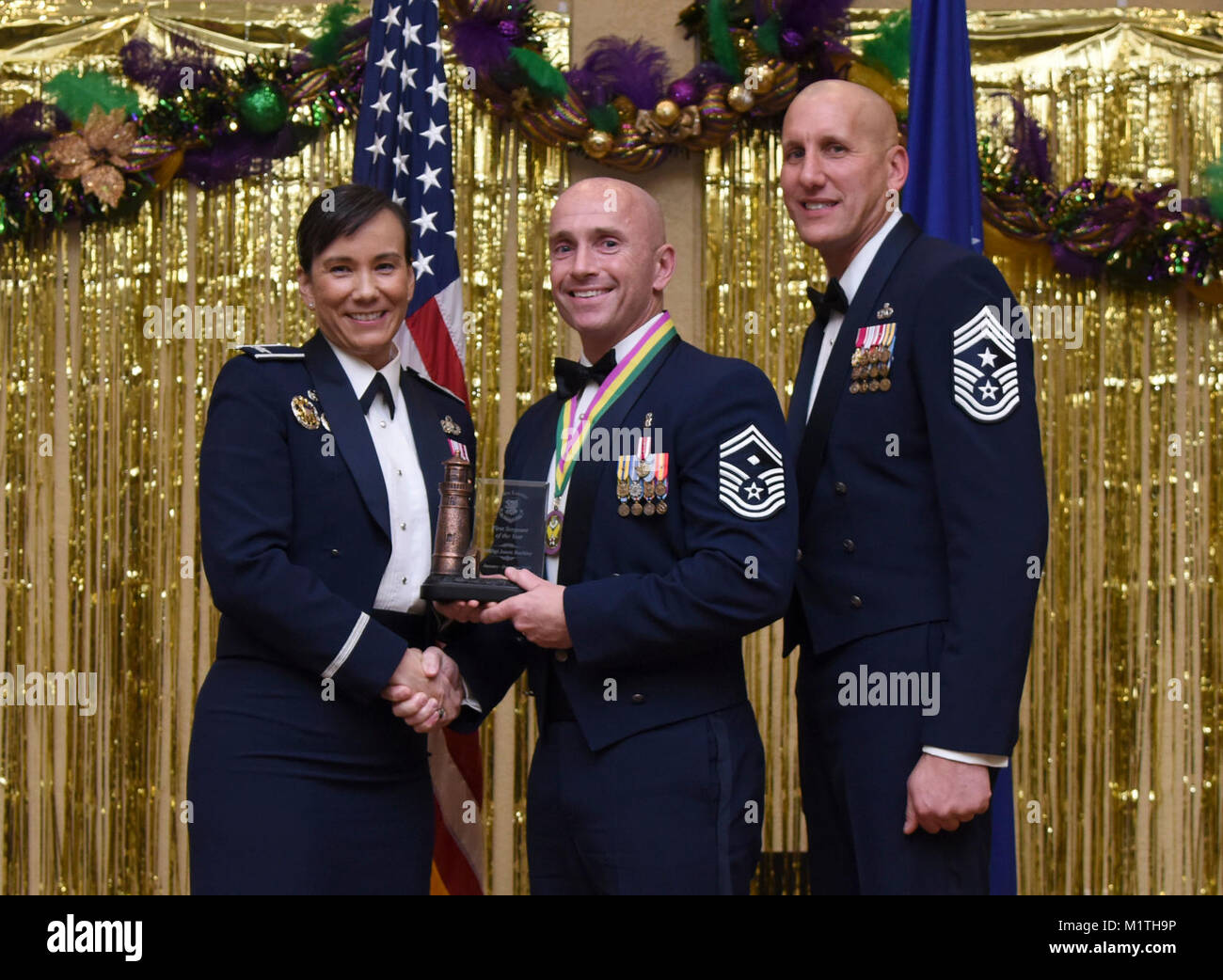 Col. Debra Lovette, 81st Training Wing commander, and Chief Master Sgt. Kenneth Carter, 81st TRW command chief, present Senior Master Sgt. Jason Buckley, 81st Medical Operations Squadron first sergeant, with the First Sergeant Annual Award during the 2017 Keesler Annual Awards Ceremony at the Bay Breeze Event Center Jan. 25, 2018, on Keesler Air Force Base, Mississippi. During the ceremony base leadership recognized outstanding Airmen and civilians from across the installation for their accomplishments throughout 2017. (U.S. Air Force Stock Photo