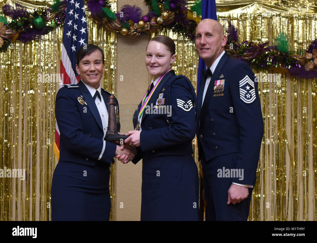 Col. Debra Lovette, 81st Training Wing commander, and Chief Master Sgt. Kenneth Carter, 81st TRW command chief, present Staff Sgt. Lauren Harris, 338th Training Squadron military training leader, with the Junior NCO Military Training Leader of the Year Annual Award during the 2017 Keesler Annual Awards Ceremony at the Bay Breeze Event Center Jan. 25, 2018, on Keesler Air Force Base, Mississippi. During the ceremony base leadership recognized outstanding Airmen and civilians from across the installation for their accomplishments throughout 2017. (U.S. Air Force Stock Photo