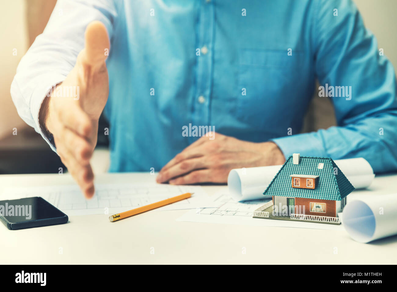 architect real estate agent offering partnership to customer in office Stock Photo