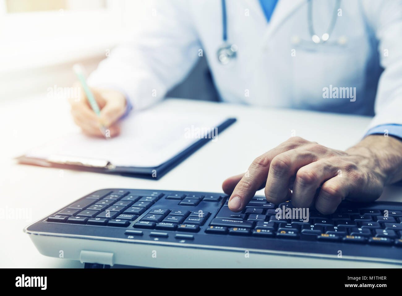 doctor working on computer in clinic office Stock Photo