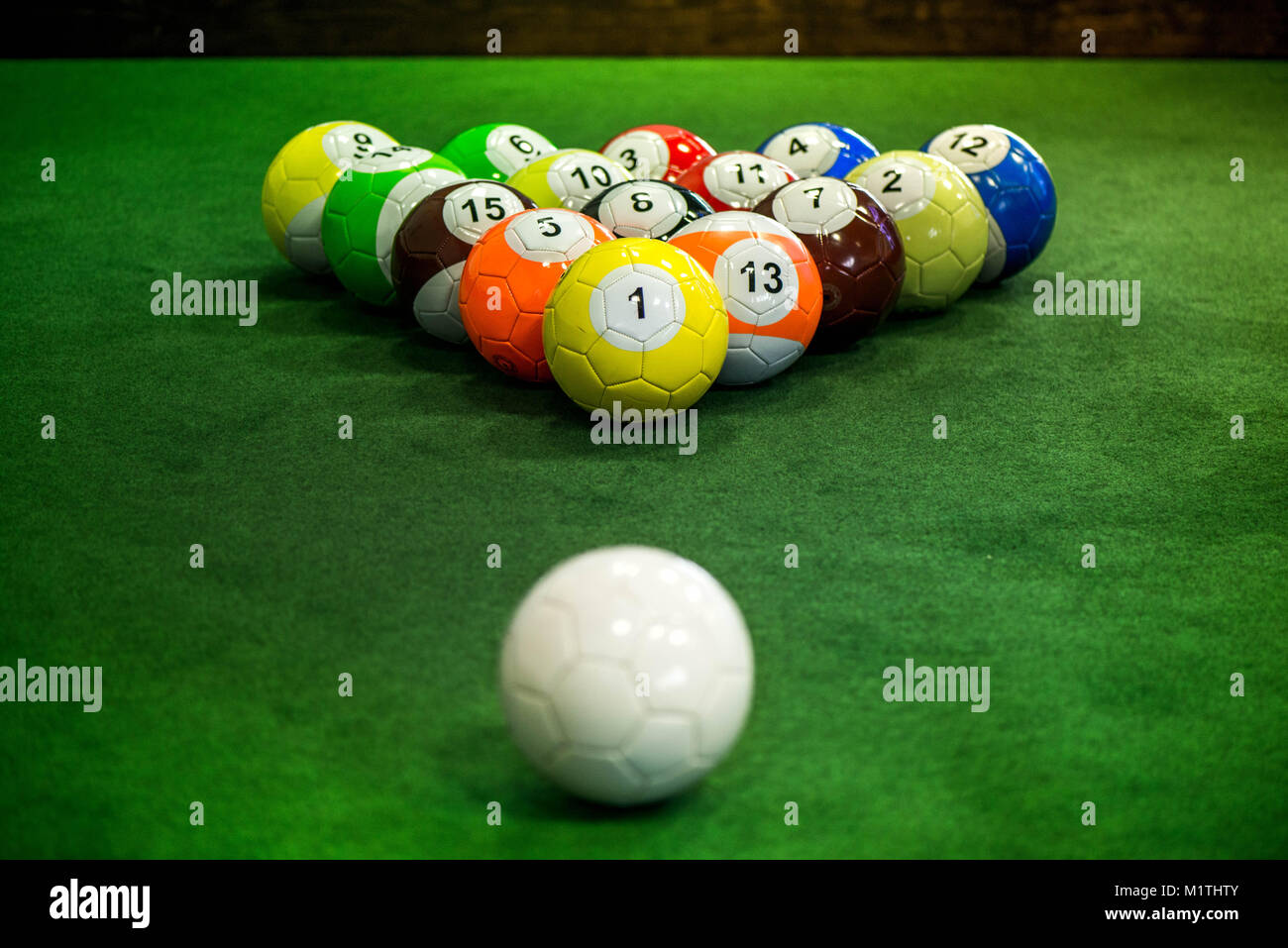 Shot of foot pool balls standing on green table. Foot Pool is the