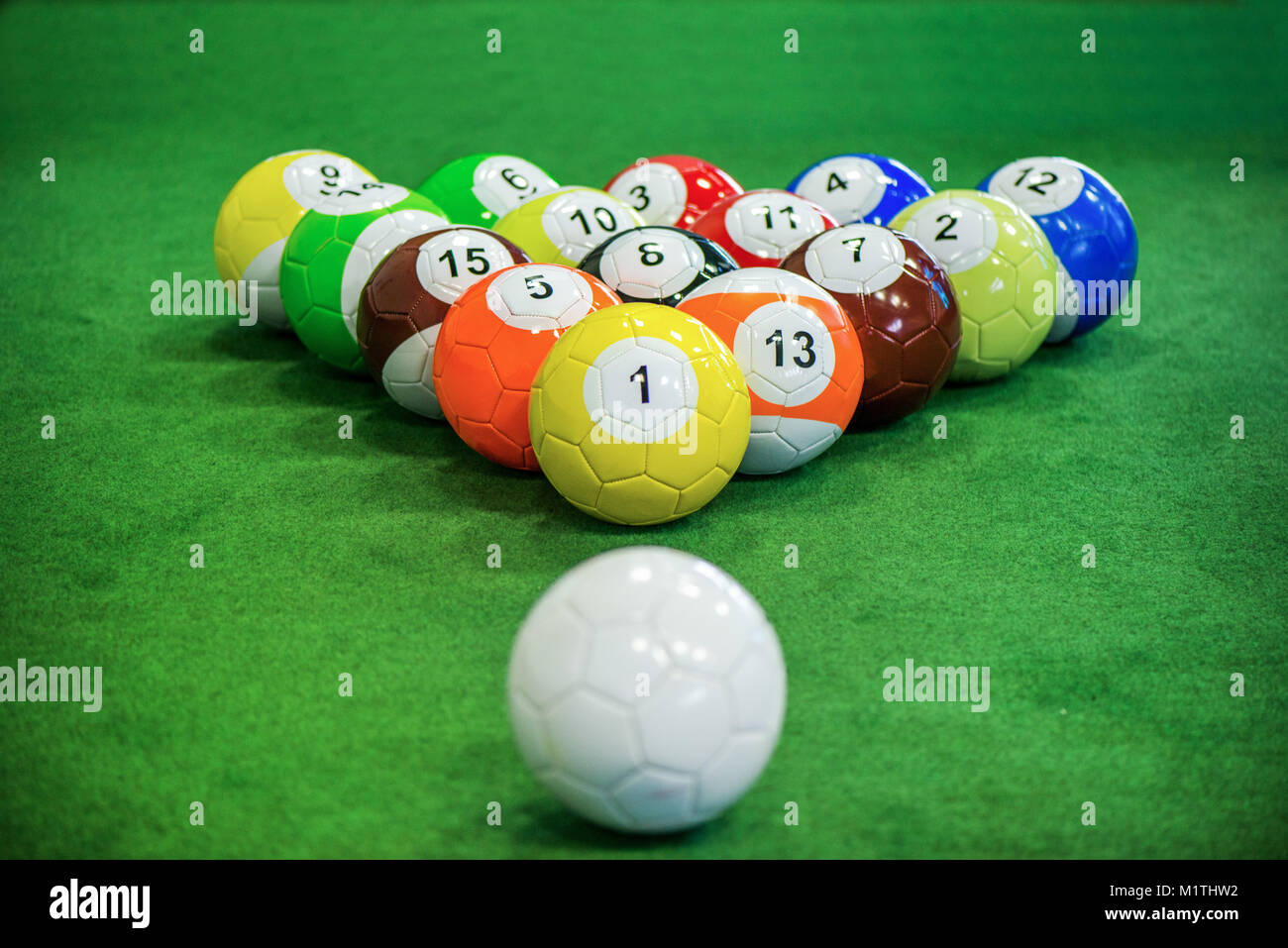 Shot of foot pool balls standing on green table. Foot Pool is the