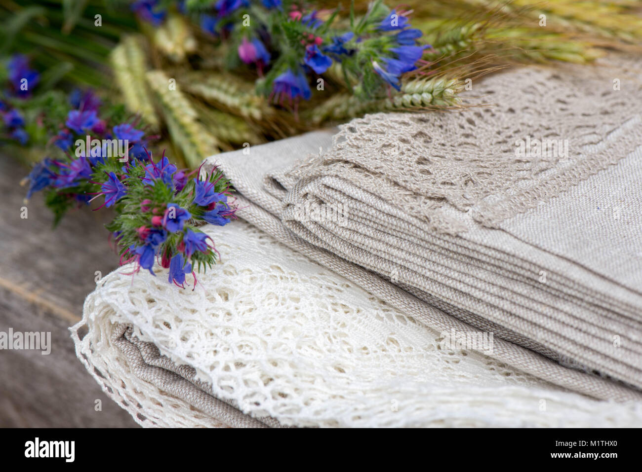https://c8.alamy.com/comp/M1THX0/shot-of-linen-tablecloths-towels-and-napkins-with-grey-and-white-lace-M1THX0.jpg