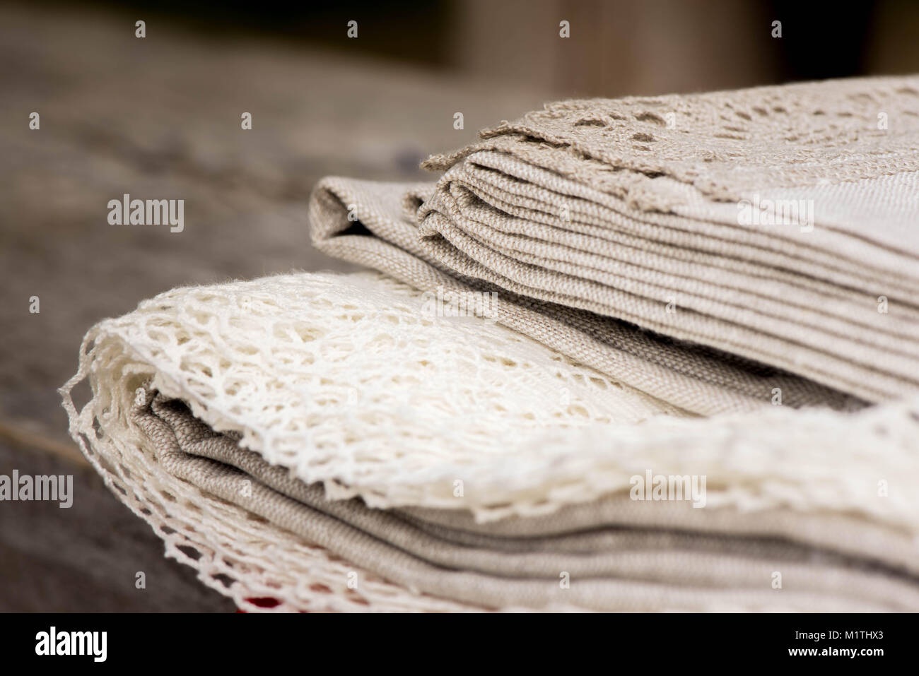 Shot of linen tablecloths, towels and napkins with grey and white lace