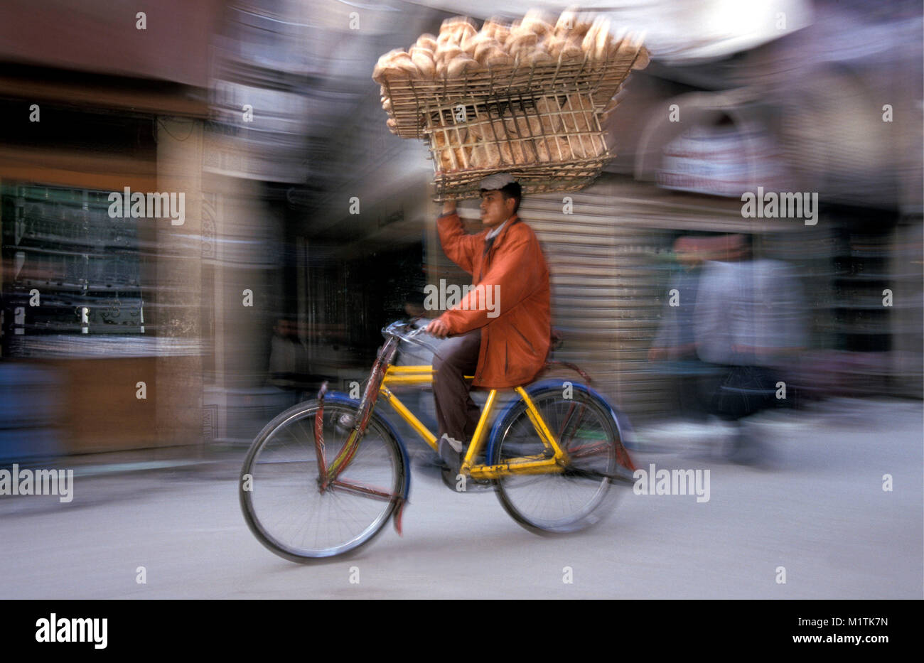 Egypt, Cairo. The great Bazaar of Khan al-Khalili. Transporting bread on bicycle. Stock Photo