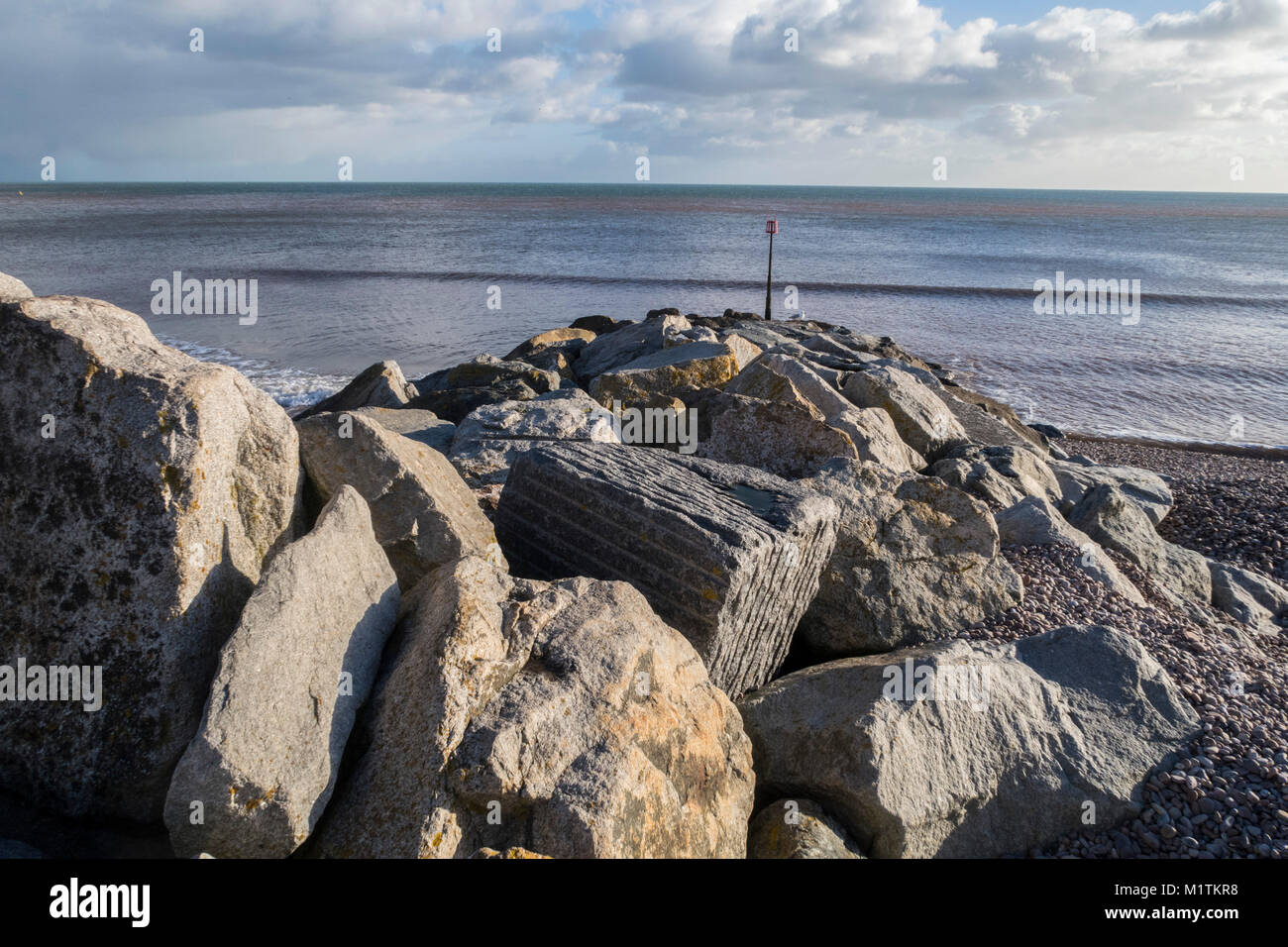 Rock sea defences on the beach at Sidmouth, Devon, England, UK. Stock Photo