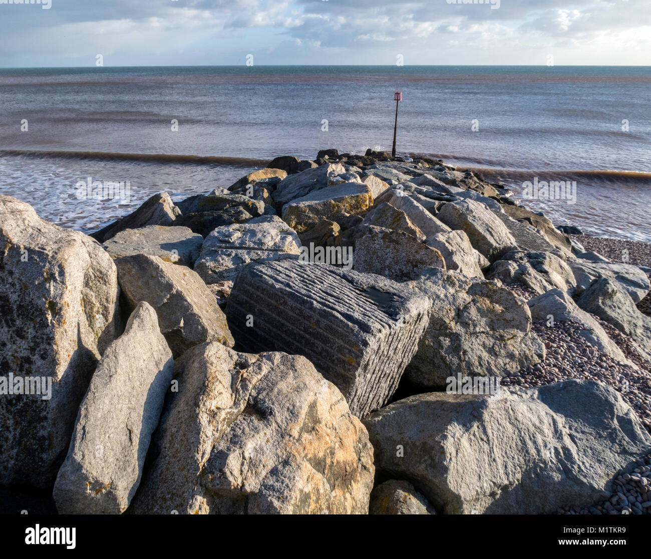 Rock sea defences on the beach at Sidmouth, Devon, England, UK. Stock Photo