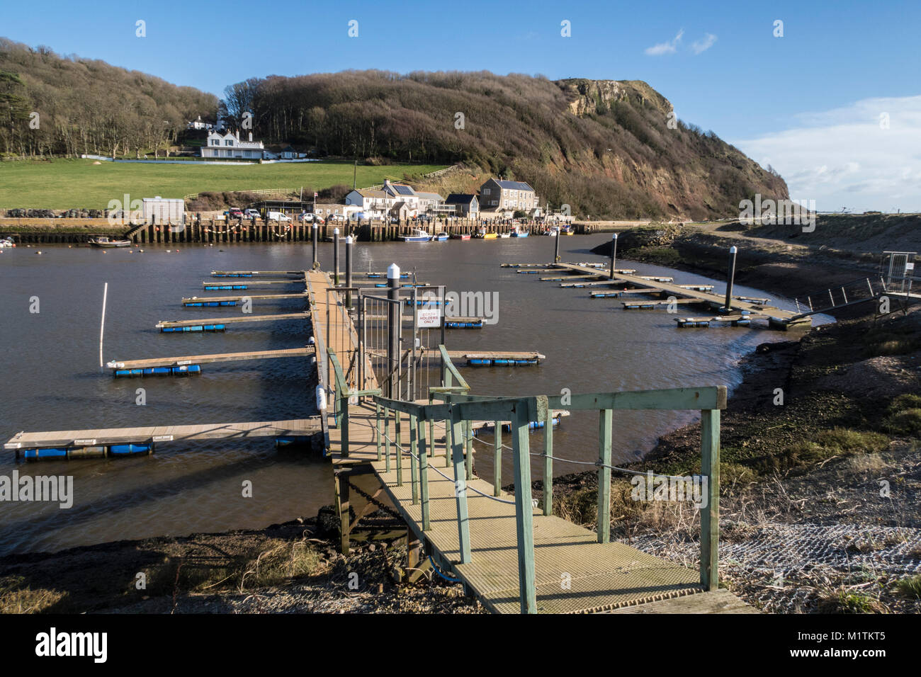 Empty berths at Axmouth Harbour, where the River Axe reaches the sea at Axmouth and Seaton. Stock Photo