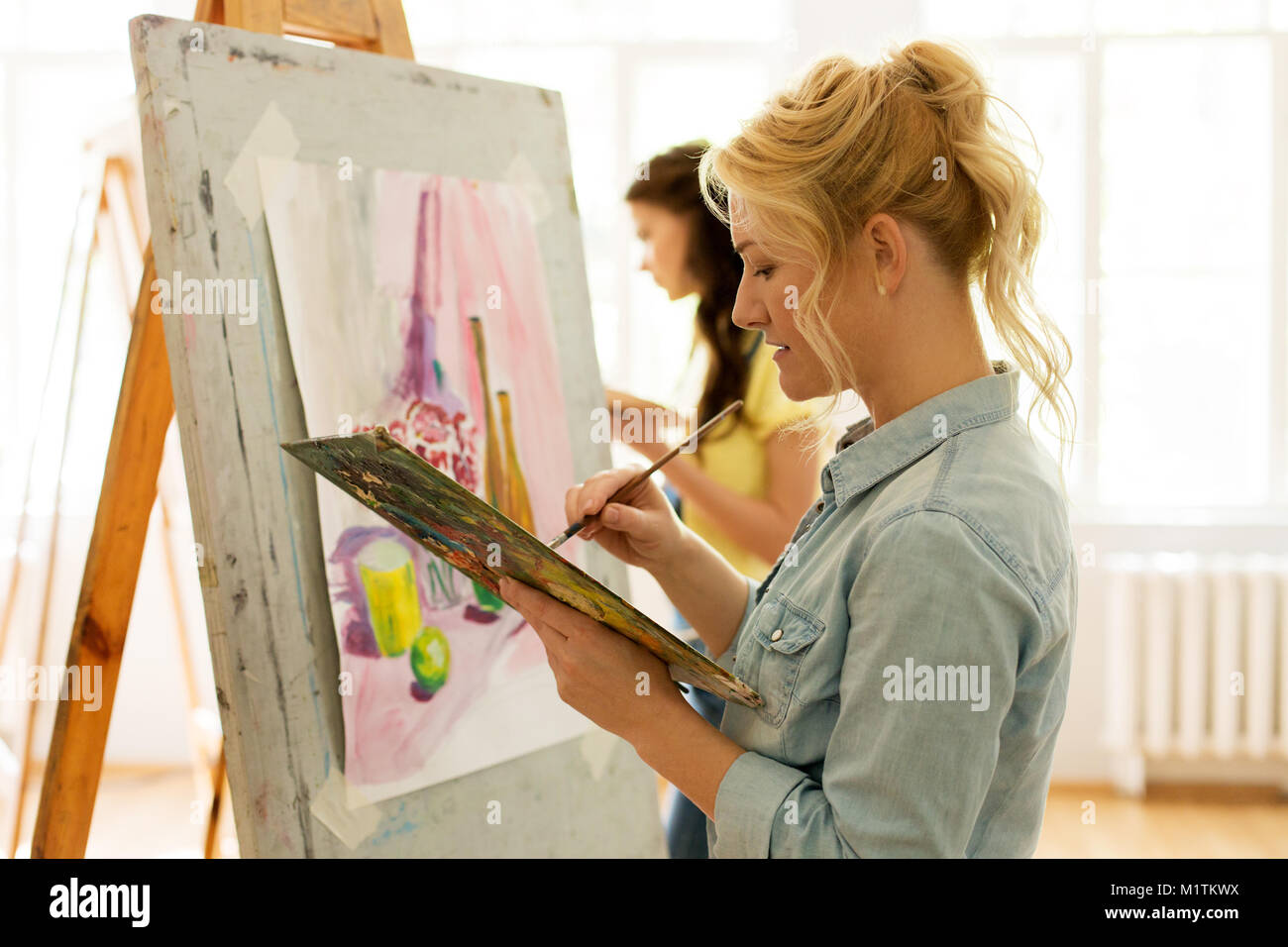 woman with easel painting at art school studio Stock Photo - Alamy
