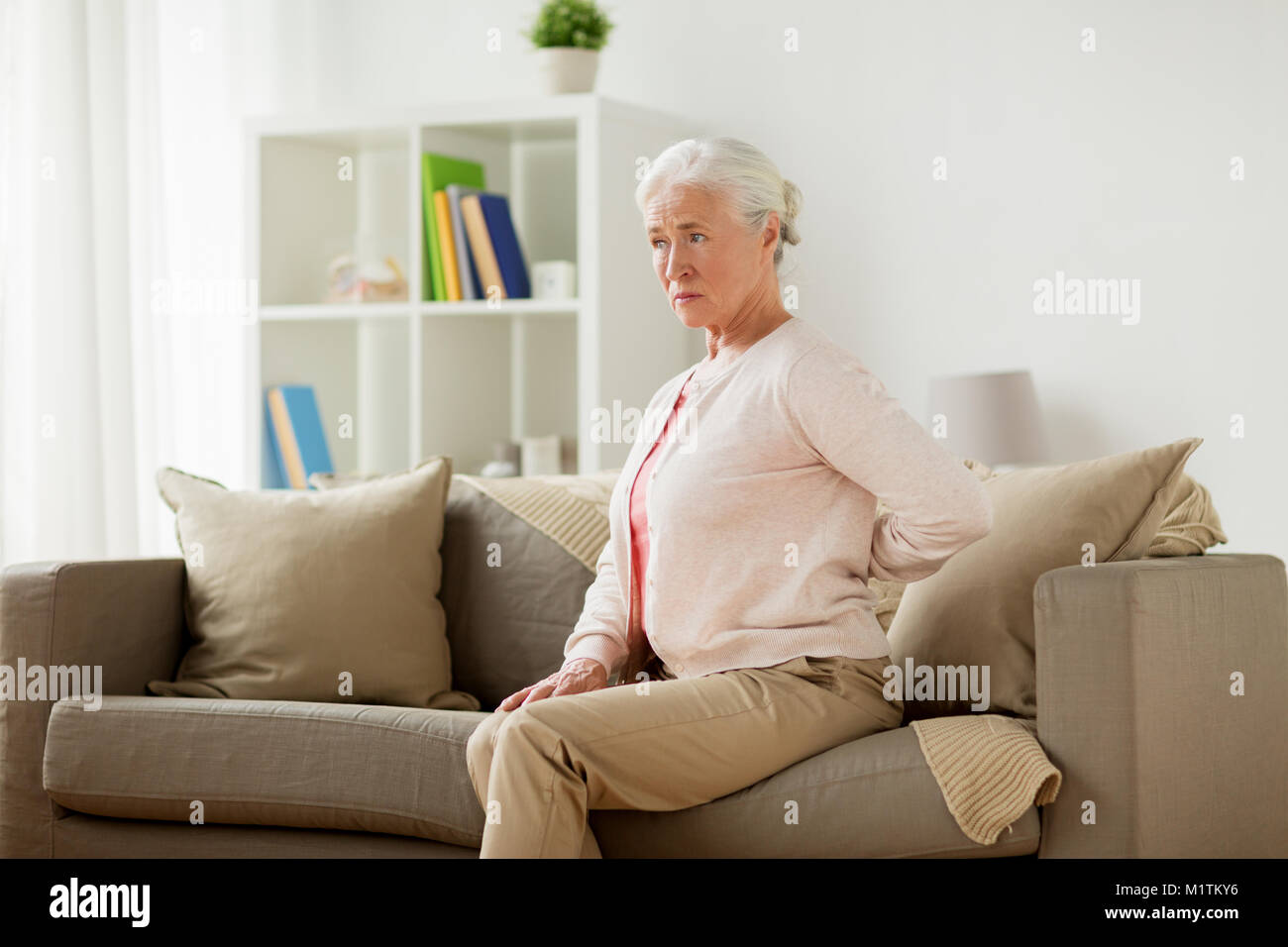senior woman suffering from pain in back at home Stock Photo - Alamy