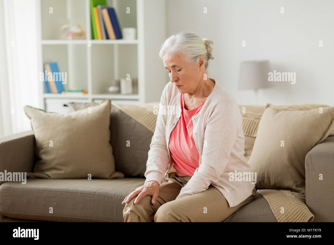 senior woman suffering from pain in leg at home Stock Photo - Alamy