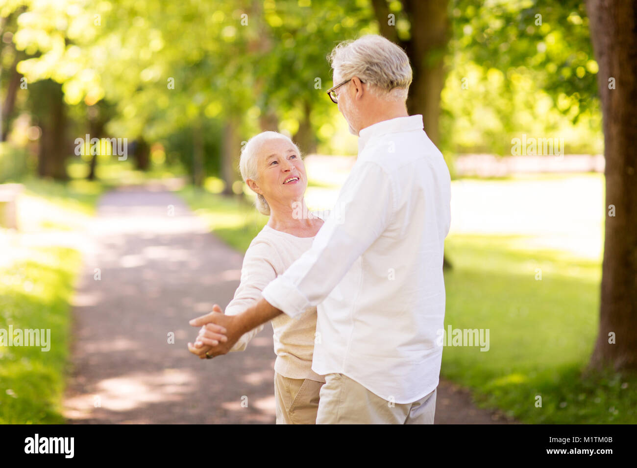 happy senior couple dancing at summer park Stock Photo - Alamy