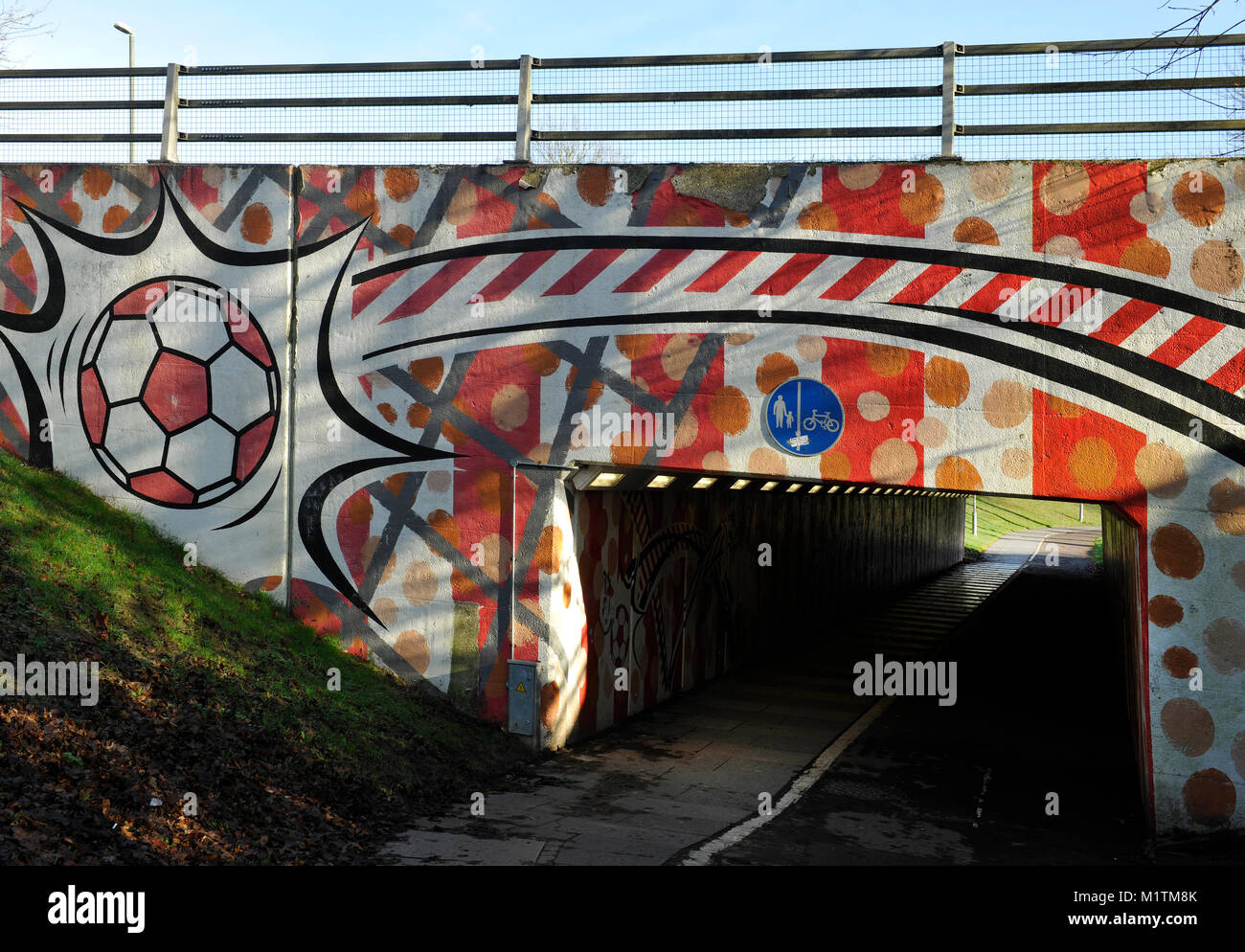 Public underpass near Crawley Town Football Stadium decorated with a football design, Crawley, West Sussex, England, UK. Stock Photo